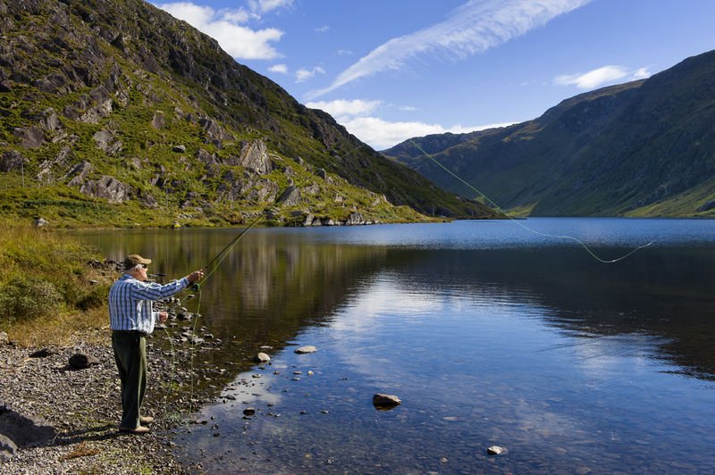 A man fly-fishing on the shore of Glenbeg Lough near Ardgroom